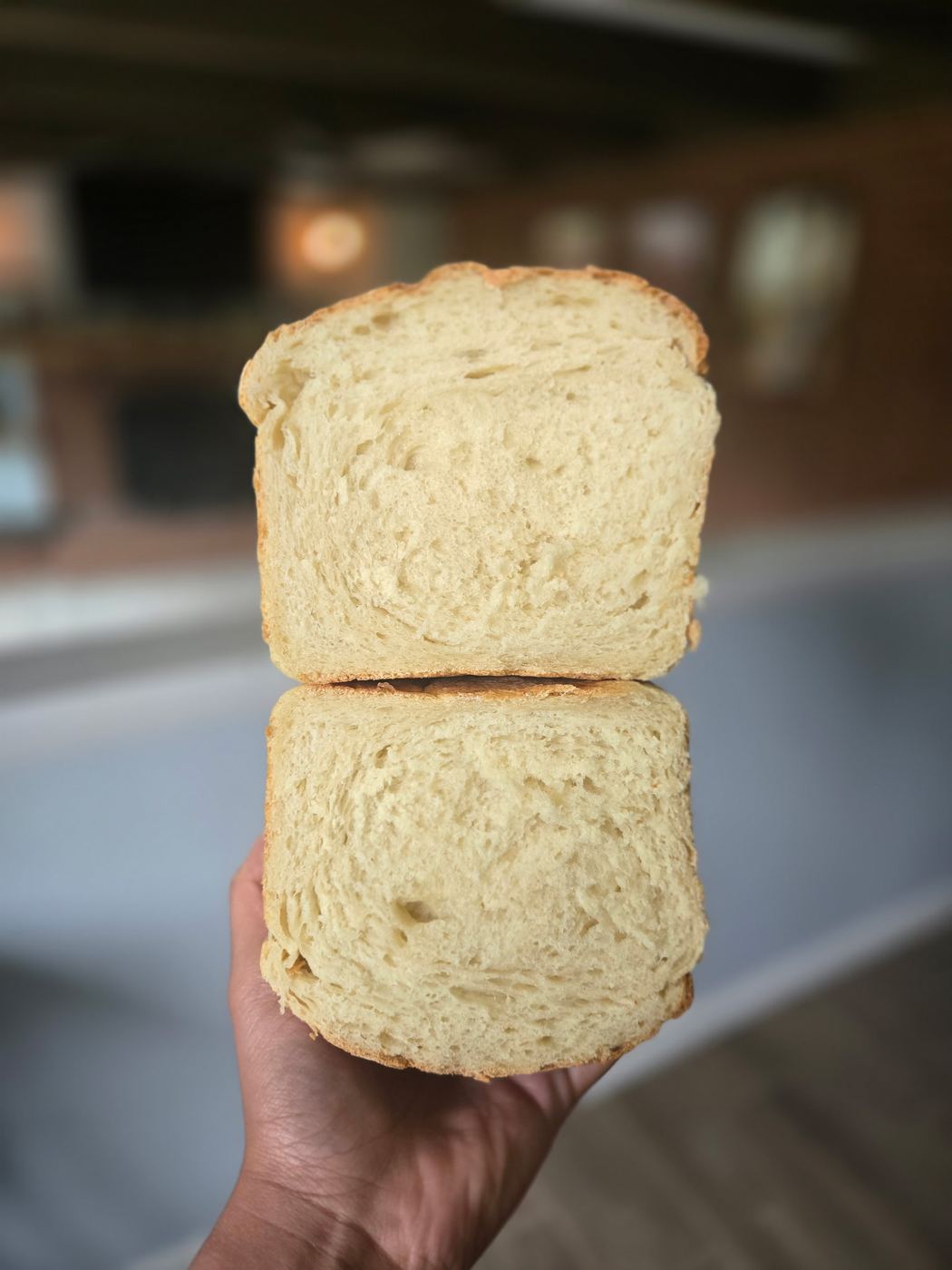 A sliced loaf of homemade sandwich bread with a soft, airy crumb